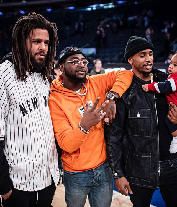 Davido pictured with US music artists, J-Cole and Trey Songs